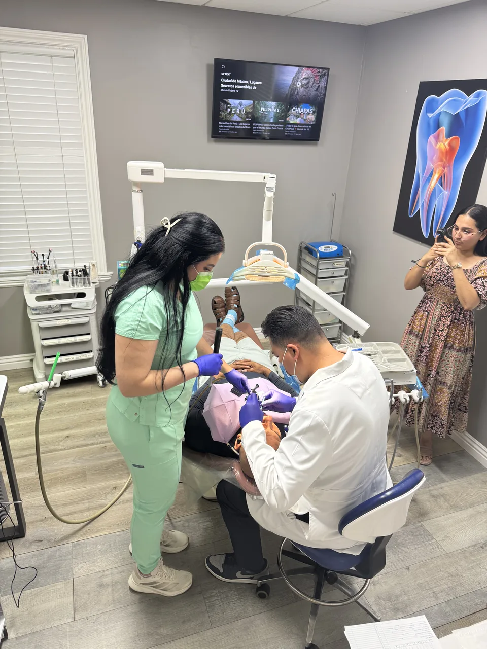 Dentist explaining a treatment plan to a patient at Latino Americano Dental