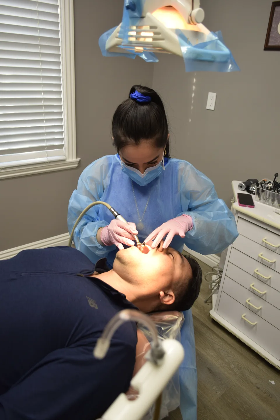 Hygienist performing a dental cleaning at Latino Americano Dental
