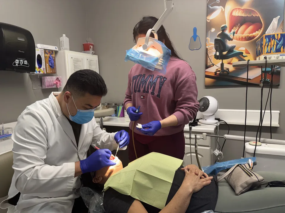 Dentist at Latino Americano Dental examining a patient at the office